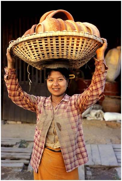 Girl burmese woman carrying traditional Burmese potteries