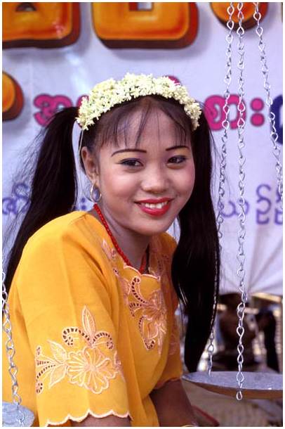 Young woman selling Burmese traditional cakes